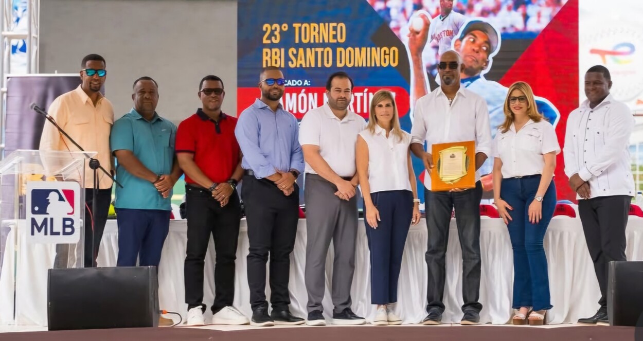 Ramón Martínez recibe su placa de reconocimiento y de izquierda a derecha Henry González, Cristian Pimentel, Ramón Santiago, Miguel Matos, Alberto Burgess, Jacqueline González, Glenys Caba y Jeffrey Reyes.