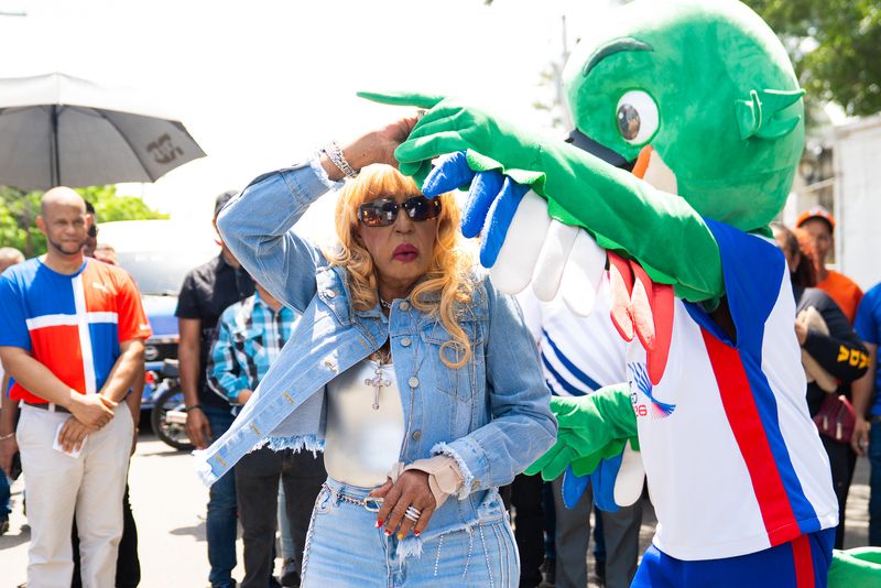 Fefita La Grande aprovecha para bailar un merenguito con Colí, la mascota de los Juegos Centroamericanos y del Caribe, durante el recorrido de la antorcha por Santiago Rodríguez.