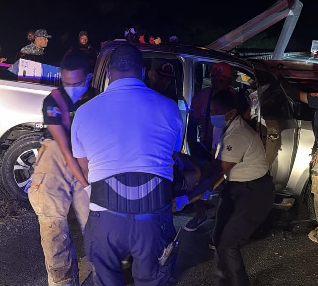 En la foto se puede ver cómo trabajadores del 911 sacan al policía del vehículo.