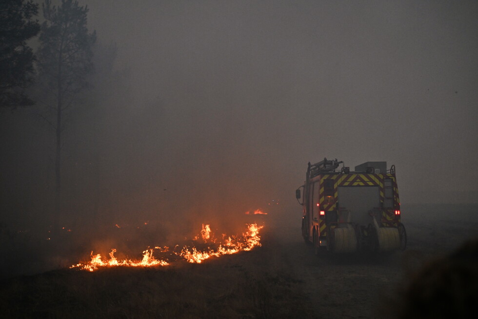 Un camión de bomberos avanza entre el humo de un incendio cerca de Marcheprime, en las afueras de Burdeos, Francia, el domingo 26 de julio de 2026.